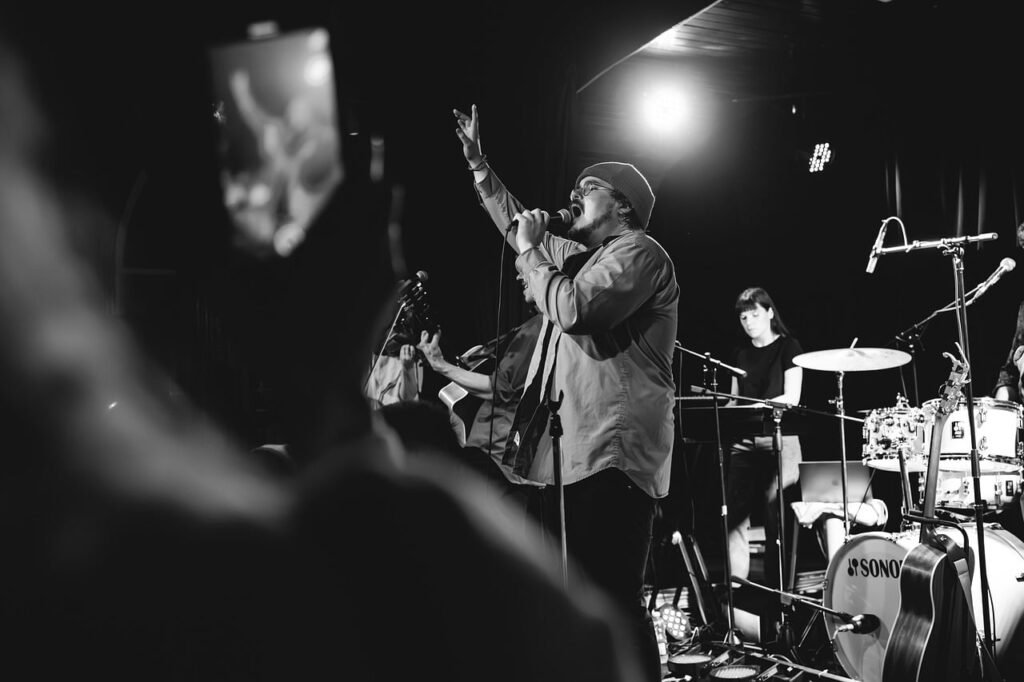 Singer and drummer on stage at a concert
