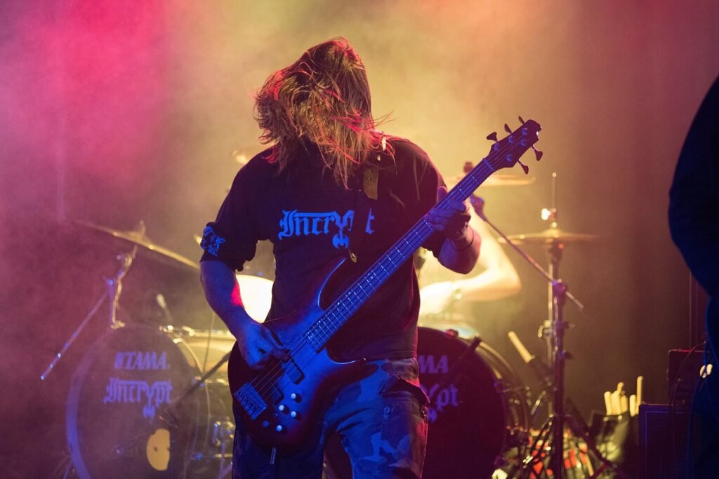 Musician playing bass guitar on stage